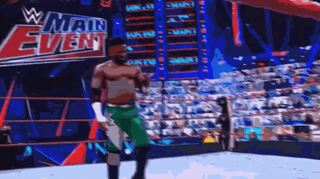 a man in a wrestling ring in front of a w main event sign