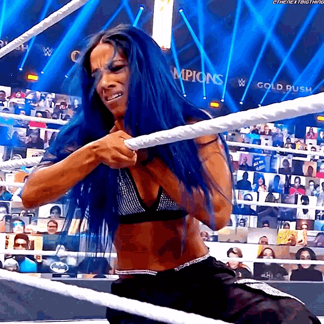 a woman in a bikini is in a wrestling ring with a sign that says gold rush