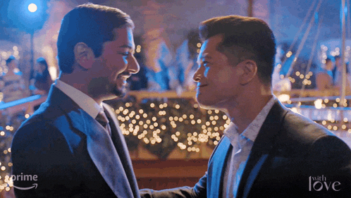 two men are looking at each other with the words " with love " on the bottom right