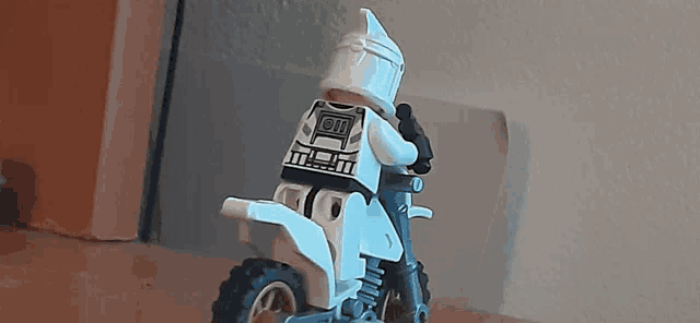 a lego clone trooper is riding a dirt bike with the number 11 on the back