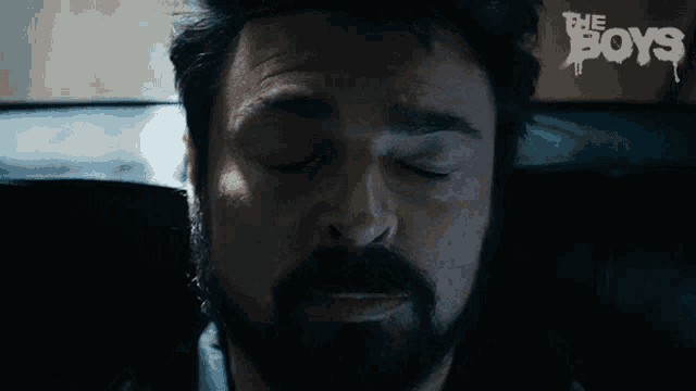a close up of a man 's face with the word boys on the bottom right