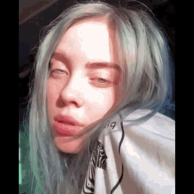 a woman with blue hair is wearing a white shirt with the number 19 on the front