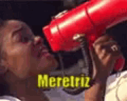 a person is holding a red hair dryer and the word meretriz is on the bottom