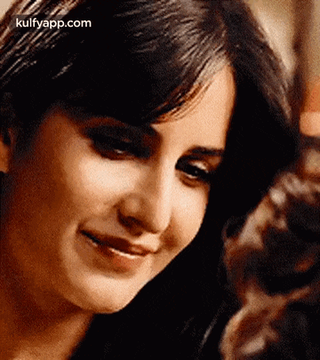a close up of a woman 's face with a smile .