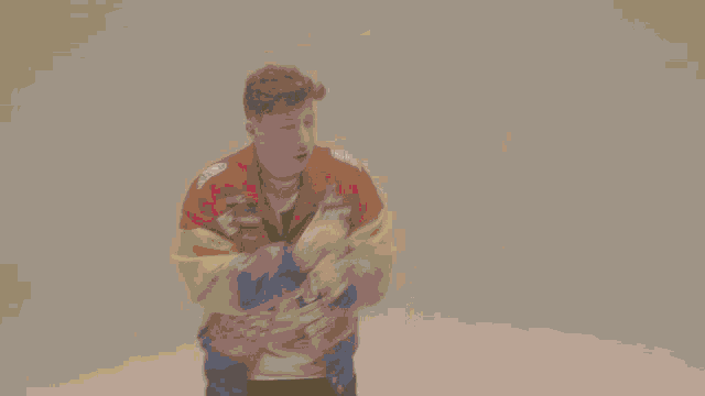 a man wearing a colorful jacket that says " uton finis " on it