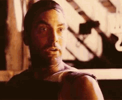 a man with a bandage on his arm is looking at the camera