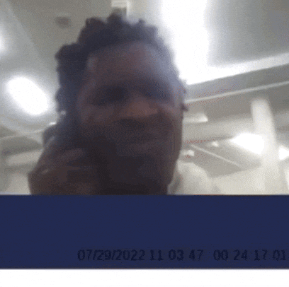 a blurry picture of a man talking on a cell phone with the date 07/29/22