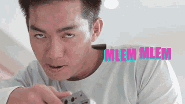 a close up of a man 's face with the word mem in pink