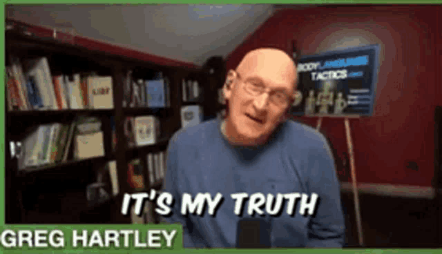 greg hartley says it 's my truth in front of a bookcase