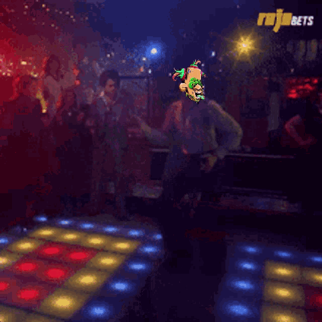 a man is dancing in front of a sign that says " rajabets "