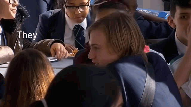 a group of people sitting around a table with the word they written on the bottom