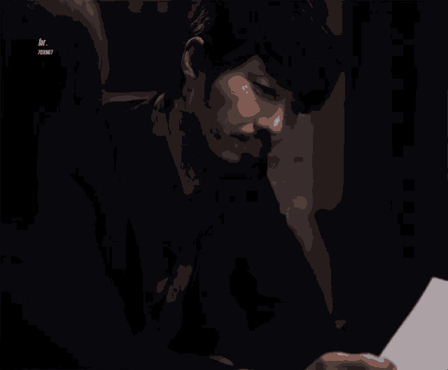 a man with a beard is looking down at a piece of paper with a watermark that says ivy