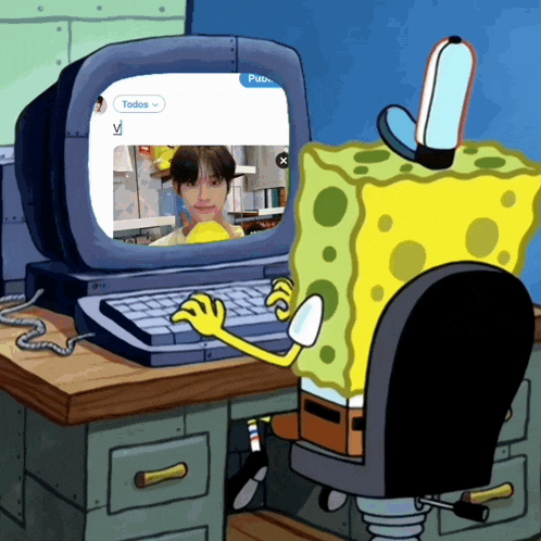a cartoon sponge sits at a desk using a computer with a screen that says todos on it