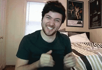 a man with a beard is giving a thumbs up in front of a poster of star wars