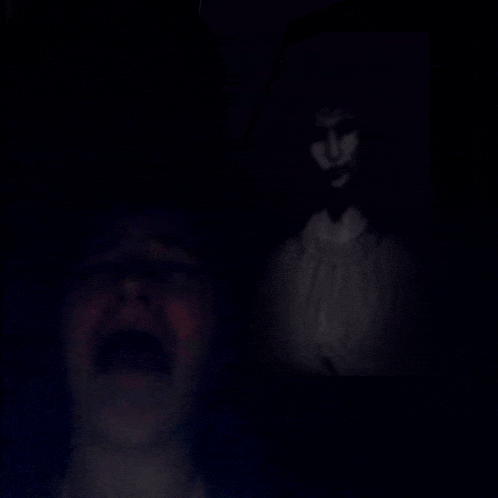 a person is screaming in the dark and a ghost is behind them