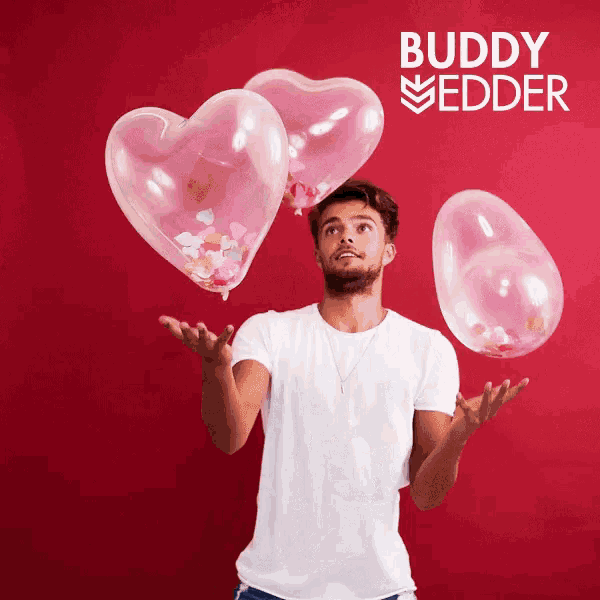 a man is juggling three heart shaped balloons in front of a red background with the name buddy medder on it