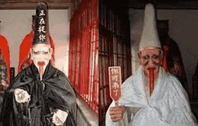 a statue of a man with blood coming out of his mouth is standing next to another statue .