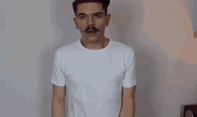 a man with a mustache wearing a white t-shirt