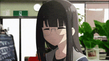 a girl with long black hair is wearing glasses and making a funny face