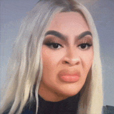 a woman with blonde hair making a funny face with her mouth open