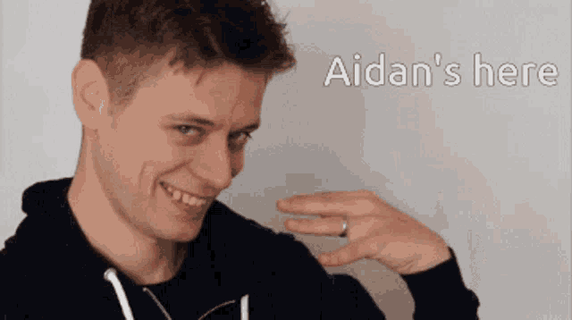 a man with a ring on his finger and the words aidan 's here on the bottom