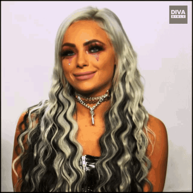 a woman wearing a choker and a necklace with diva written on the bottom