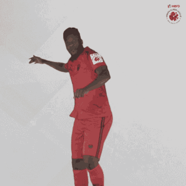 a man in a red jersey and shorts is dancing