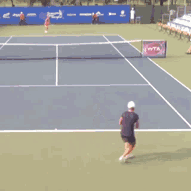 a tennis court with a wta sign on the side