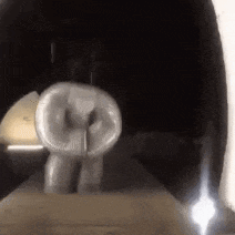 a person is standing in a tunnel with a balloon in their mouth .