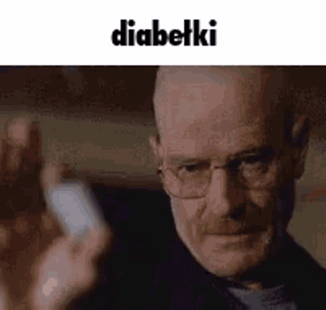 a man wearing glasses is holding a cell phone in his hand and making a funny face .