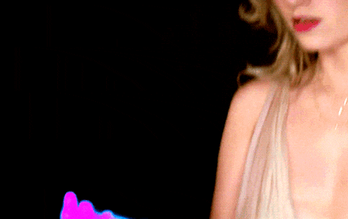 a woman in a white dress holds a blue object