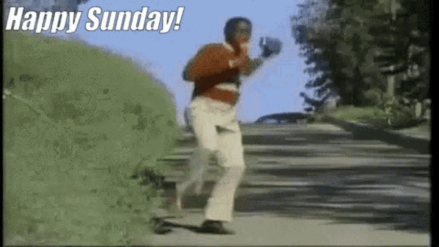 a man is running down a hill with the words `` happy sunday '' written on the bottom .