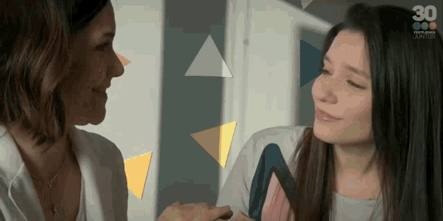 two women are looking at each other with the number 30 on the bottom left
