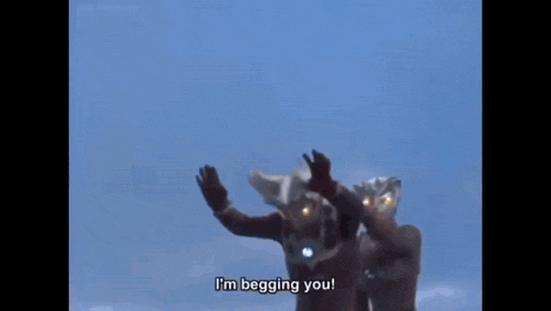 a group of ultraman are standing next to each other in a row .