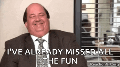 a bald man in a suit and tie is smiling and laughing .