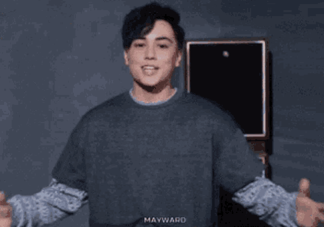 a man wearing a sweater that says manwark on it