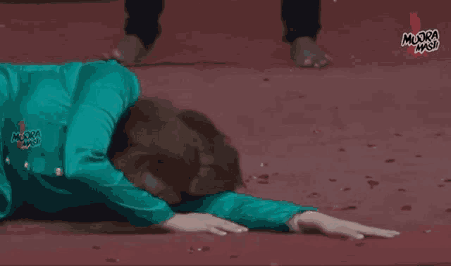 a person is laying on their stomach on a red carpet .