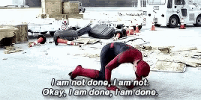 a man in a spiderman suit is kneeling on the ground and saying okay i am done i am done