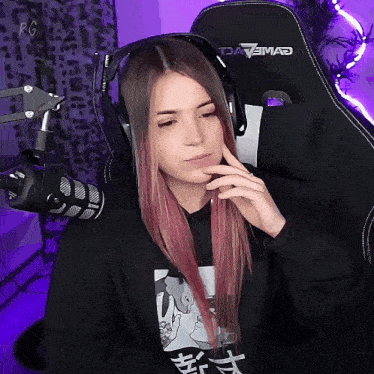 a woman wearing headphones sits in a gaming chair that says davemad