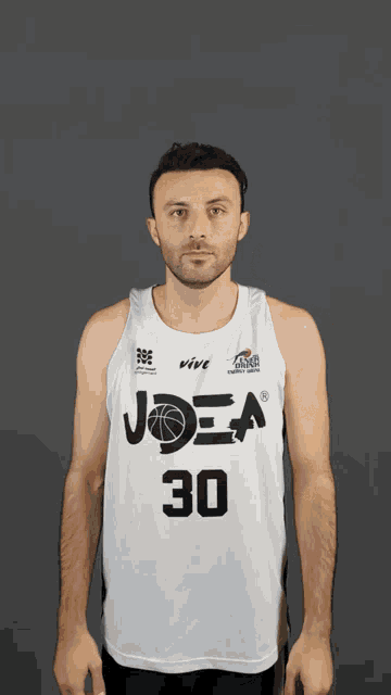 a man wearing a white joea jersey number 30