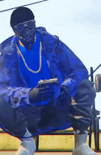 a man wearing sunglasses and a bandana is holding a gun