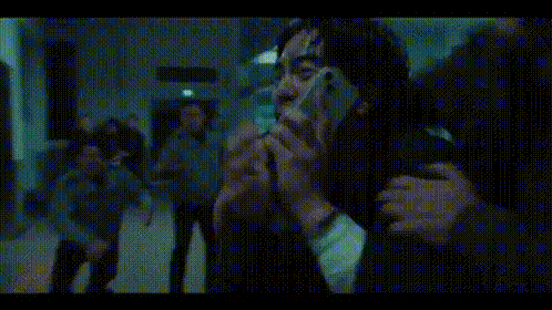 a group of men are taking a picture of themselves with their phones .