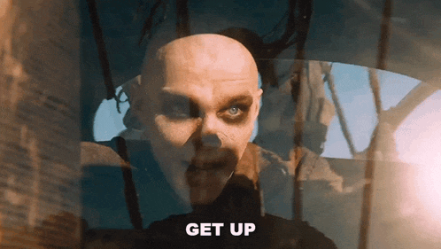 a close up of a man 's face with the word get up written below it