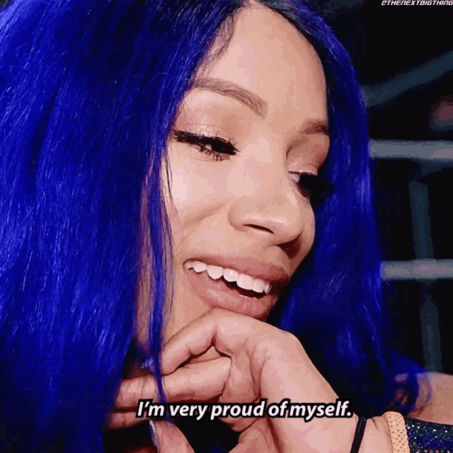 a woman with blue hair smiles and says i 'm very proud of myself