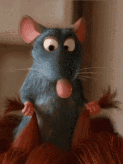 a close up of a cartoon mouse holding a pair of hair brushes .