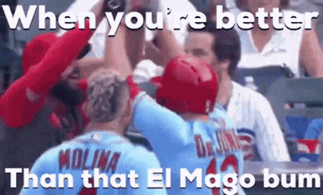 two baseball players are giving each other a high five in front of a crowd at a baseball game .