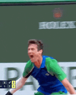 a man in a blue and green shirt is screaming in front of a scoreboard that says rolex