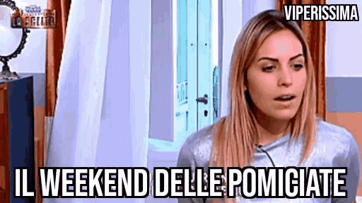 a woman is sitting in front of a mirror in a room with the words `` il weekend delle pompicate '' written below her .