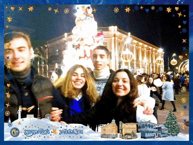 a group of people are posing for a picture in front of a christmas tree with a blue background that says georgian