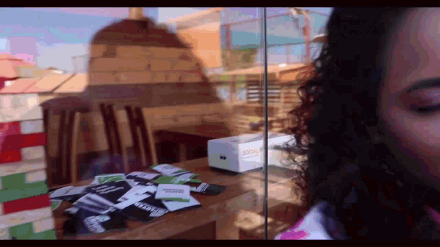 a woman is standing in front of a glass door with a box that says scale on it
